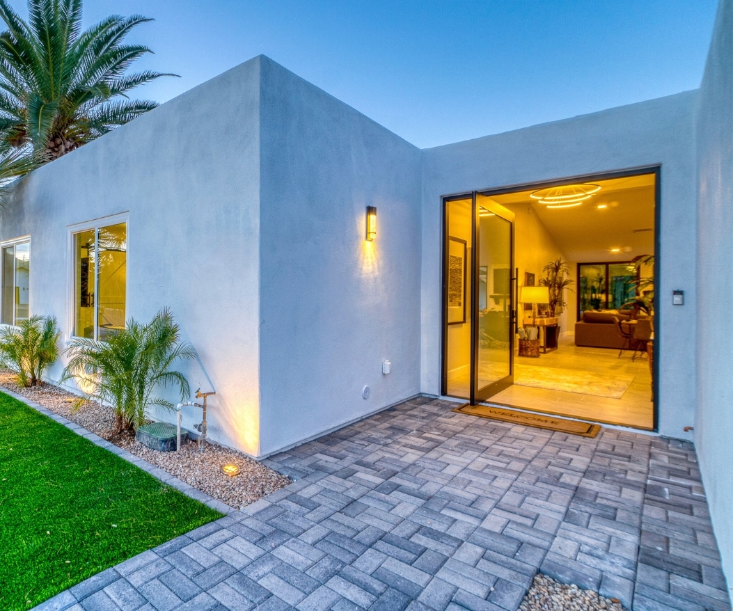 Modern attached ADU with a well-lit entrance and landscaped surroundings