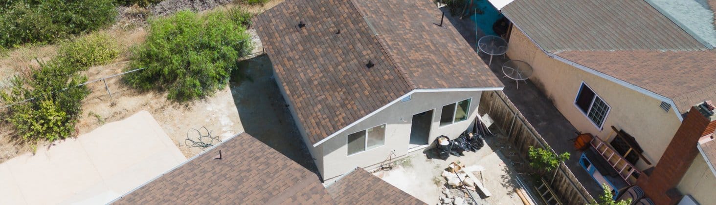 Aerial view of an ADU construction project with solar panels on the main house