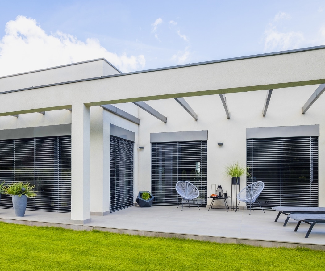 Contemporary room addition featuring a patio and stylish exterior design