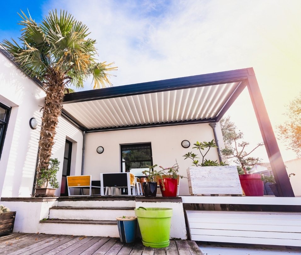 a white house with a palm tree and a porch