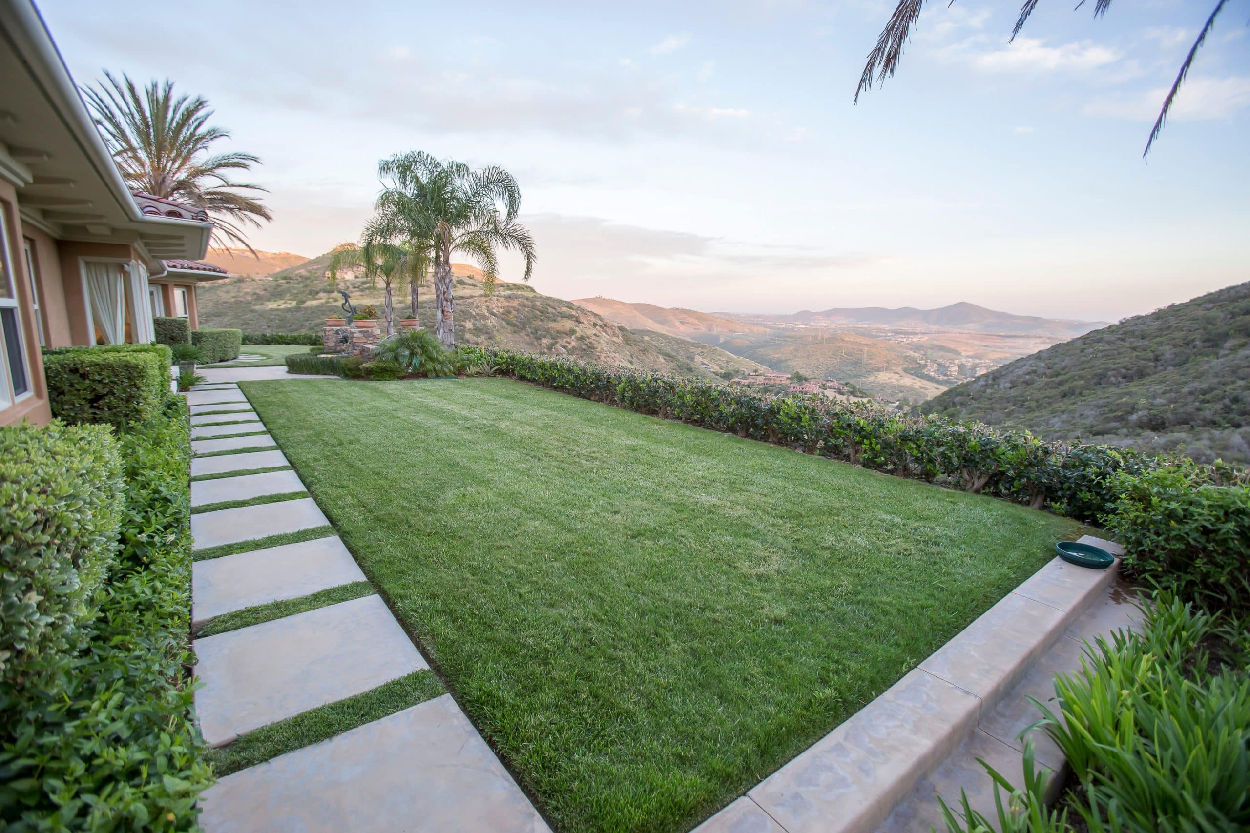 Couple in front of their California home for sale, illustrating the benefits of AB 1033 for selling ADUs separately.